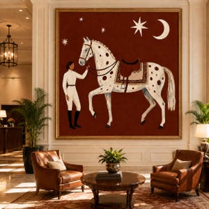 May include: A large square wall art piece featuring a white horse with brown spots and a brown saddle, standing next to a figure in white equestrian attire. The background is a deep rust red color with a white crescent moon and several stars.