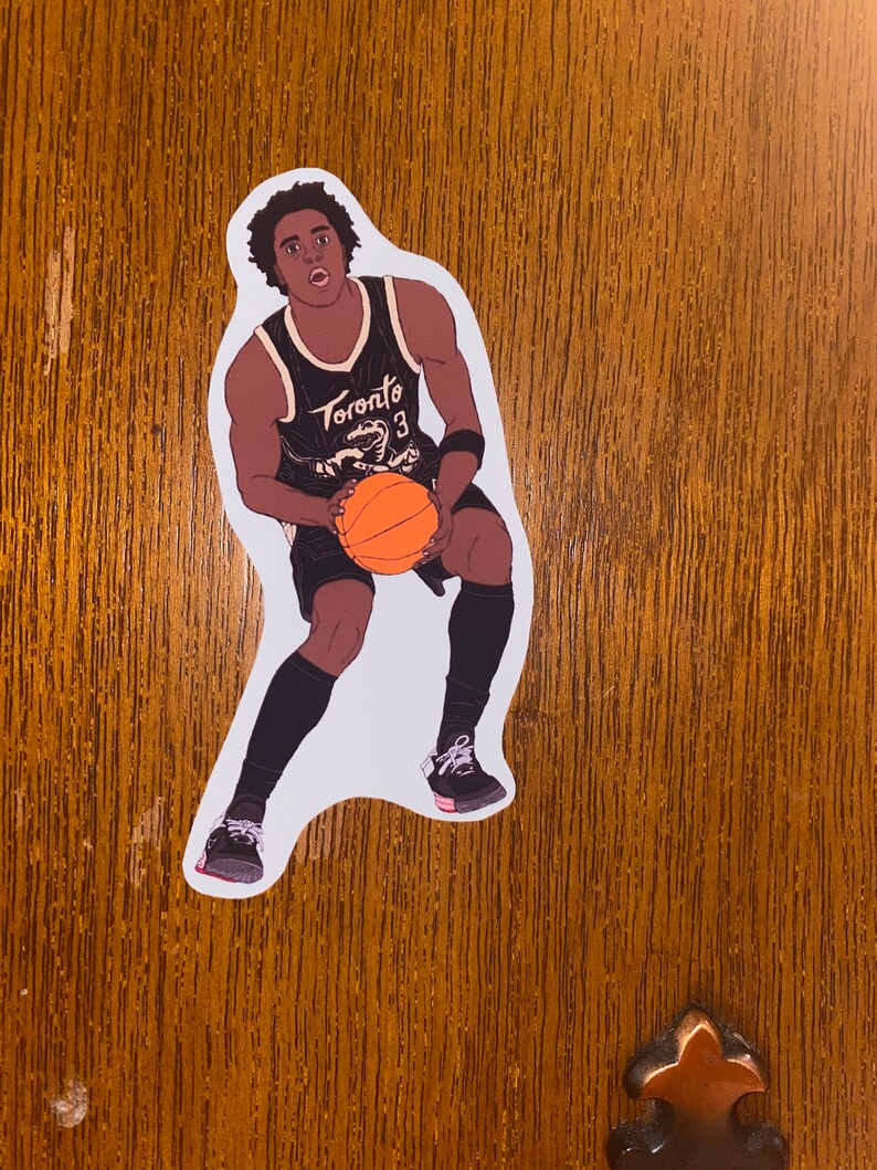 May include: A black and white illustration of a basketball player wearing a black jersey with the word "Toronto" and the number "3" on it. The player is dribbling an orange basketball.
