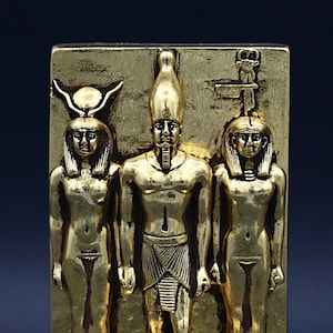Triads of Menkaure Pharaoh, stands between the goddess Hathor and his wife Made by hand from stone covered by gold leaf, made in egypt
