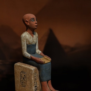 Statue of Egyptian art Seated statue of Imhotep god of midicine holding an open papyrus scroll STONE made in egypt