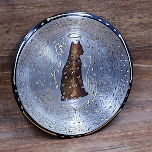 Handcrafted copper plate engraved with the protector of homes, Goddess Bastet, hanging on the wall