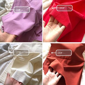 May include: Four fabric swatches in different colours: light purple, red, off-white, and orange-brown. Each swatch is labelled with a number: 25#, 26#, 27#, and 28#.