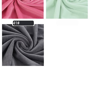 May include: Three fabric swatches in different colors. The first swatch is a bright pink, the second is a light green, and the third is a dark gray.