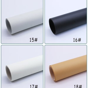 May include: Four rolls of faux leather in different colors: white, black, white, and beige. The rolls are labeled with numbers 15, 16, 17, and 18.