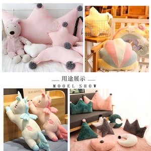 May include: A set of plush pillows in various shapes, including a crown, a star, a crescent moon, and a cloud. The pillows are made of soft, colorful fabric and are perfect for adding a touch of whimsy to any room.