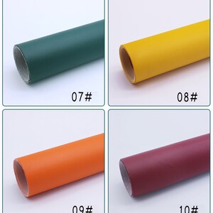 May include: Four rolls of faux leather in different colors: green, yellow, orange, and burgundy. Each roll is labeled with a number.