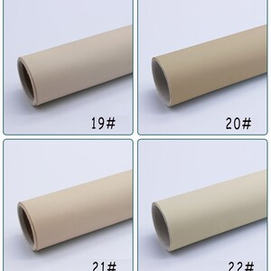 May include: Four rolls of beige faux leather fabric, each with a different shade of beige. The rolls are labeled 19#, 20#, 21#, and 22#.