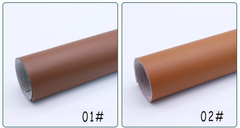 May include: Two rolls of brown faux leather fabric. The roll on the left is a darker brown and the roll on the right is a lighter brown. The rolls are labeled 01# and 02#.