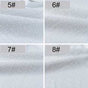 May include: A collection of four white cotton fabrics featuring intricate eyelet embroidery patterns. Each swatch is labeled with a number: 5#, 6#, 7#, and 8#. The designs include various floral motifs, small circular cutouts, and zigzag lines.