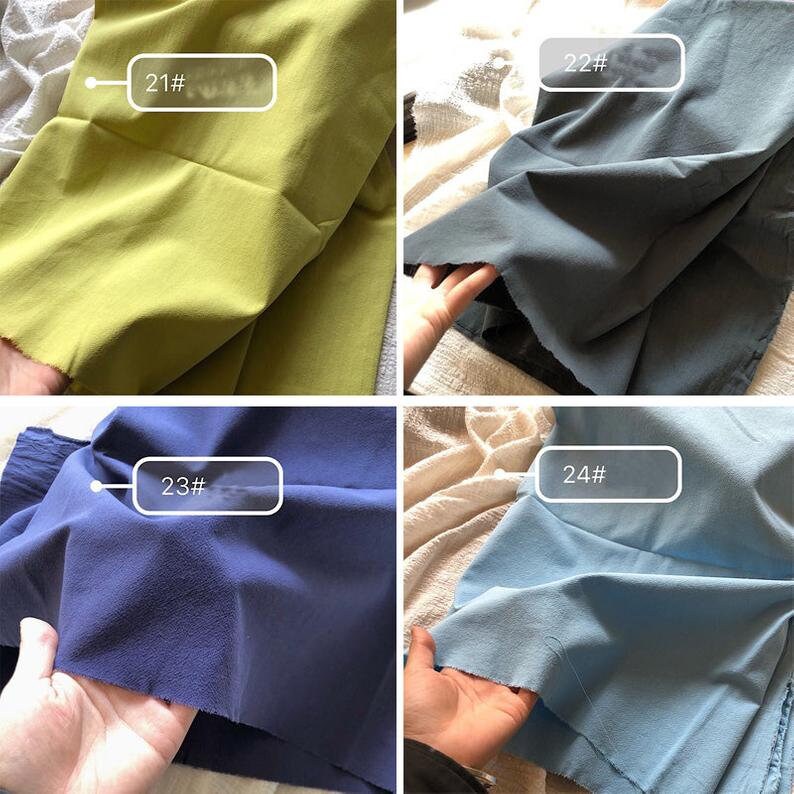 May include: Four fabric swatches in different colours: a bright yellow-green, a medium blue-grey, a dark navy blue, and a light blue. Each swatch is labelled with a number: 21#, 22#, 23#, and 24#.