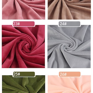 May include: Six fabric swatches in different colors. The swatches are arranged in two rows of three. The colors are pink, brown, red, gray, green, and peach.