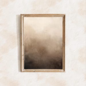 Può includere: Un dipinto astratto incorniciato con un gradiente dal marrone chiaro al marrone scuro. La cornice è in legno chiaro e semplice.