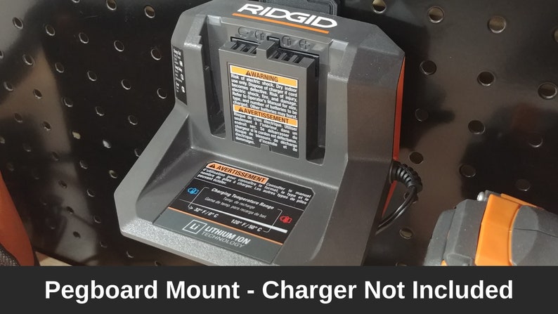 May include: A black and orange pegboard mount for a Ridgid charger. The charger is not included. The mount has a label that says "Lithium Ion Technology".
