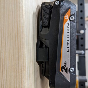 May include: A black and orange power tool battery with the text "2Ah LITHIUM 18V" on the side.