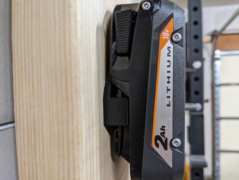 May include: A black and orange power tool battery with the text "2Ah LITHIUM 18V" on the side.