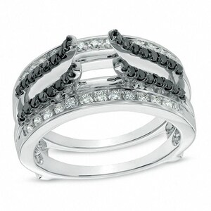 May include: A silver ring with a double band design. The top band features a row of black diamonds and the bottom band features a row of white diamonds.