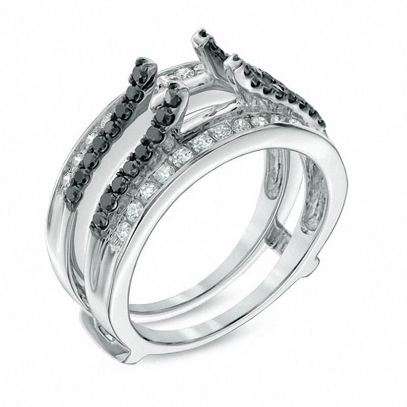 May include: A silver ring setting with a double band design. The outer band is set with small round white diamonds and black diamonds. The inner band is set with black diamonds.