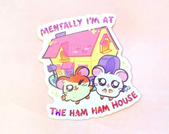May include: A sticker featuring two cartoon hamsters in front of a pink and yellow house. The text "Mentally I'm at The Ham Ham House" is written on the sticker.