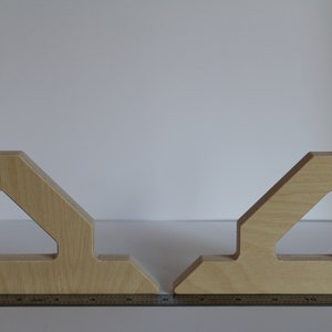 May include: Two wooden corner brackets with intricate cutouts, each measuring approximately 12 inches in length. The brackets are made of light-colored wood and have a natural finish.