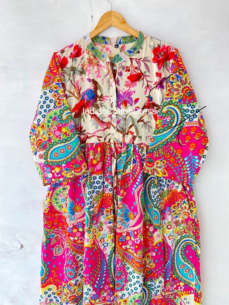 May include: A colorful, long-sleeved dress with a paisley print. The dress has a button-up front and a tie at the waist. The dress is made of cotton and is available in a variety of sizes.