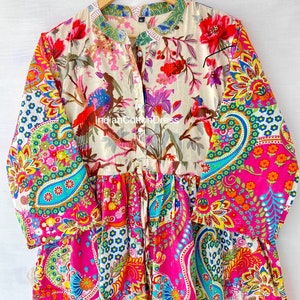 May include: A colorful, floral print dress with a button-up front and long sleeves. The dress has a paisley pattern on the bottom half and a floral pattern on the top half. The dress is made of cotton and is available in a variety of sizes.