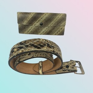 May include: A brown snakeskin belt with a silver buckle and a matching snakeskin wallet.