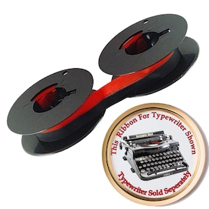 May include: A black typewriter ribbon on two plastic spools with a red and black ink strip. A circular badge features a black Remington Rand typewriter with the text: This Ribbon For Typewriter Shown, Typewriter Sold Seperately.