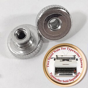 May include: Two silver metal nuts with a threaded hole in the center. The nuts are designed to fit on a typewriter spool. The image also includes a picture of a typewriter with the text "Two Spool Nuts For Typewriter Shown Typewriter Sold Separately".