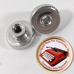May include: Two silver spool nuts for a typewriter. The nuts have a knurled edge and a threaded center. A circular graphic shows a red typewriter and text that reads "Two Spool Nuts For Typewriter Shown, Typewriter Sold Separately."