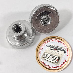 May include: Two silver spool nuts for a typewriter. The nuts have a knurled edge and a threaded center. A circular graphic shows a typewriter and text that reads "Two Spool Nuts For Typewriter Shown. Typewriter Sold Separately."