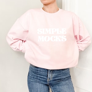 May include: A pink sweatshirt with the text "SIMPLE MOCKS" in white lettering.