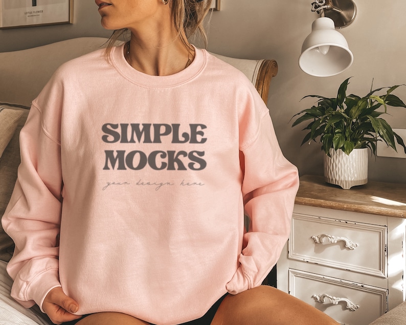 May include: A pink sweatshirt with the text "SIMPLE MOCKS your design here" in a retro font.