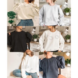 May include: Five different colored sweatshirts, each with a crew neck and long sleeves. The sweatshirts are shown on five different models, each wearing a different color. The colors are beige, gray, black, white, and dark blue.