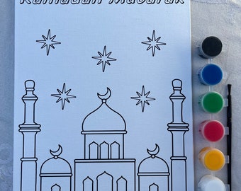 May include: A paint-by-numbers kit featuring a mosque with minarets and stars. The kit includes a canvas, paint pots in black, blue, green, red, yellow, and white, and a paintbrush.