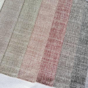 May include: A close-up of a variety of fabric swatches in different shades of beige, pink, and gray. The swatches are arranged in a row, with the lightest shade at the top and the darkest shade at the bottom.