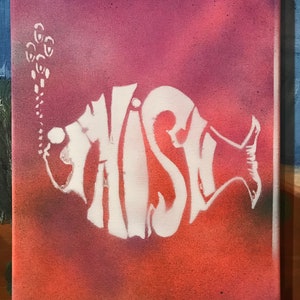 May include: A white spray-painted fish with the word "FISH" inside, on a pink and red canvas background.