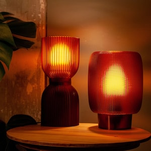 DIABOLO lamp in a cozy reading nook providing inviting warm ambient lighting. Handcrafted from recycled plastic for a sustainable touch. Fits perfectly in modern, minimalist, or boho interiors to create an inviting atmosphere.
