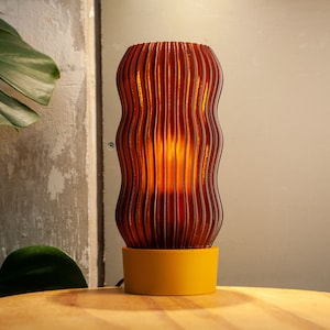 Ochre yellow WAVY x AMBER table lamp with retro minimal design. Perfect for living room or bedside lighting with a warm glow, made from recycled materials.