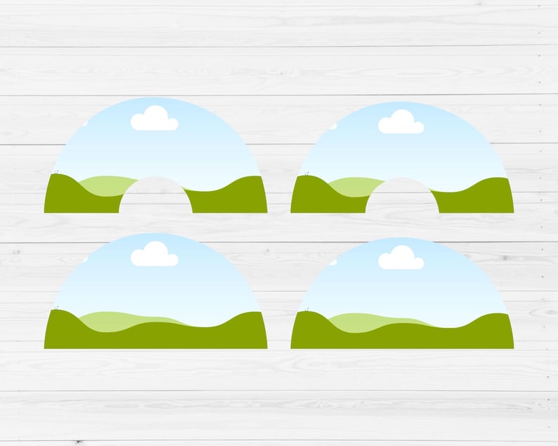 May include: Four printable cupcake toppers featuring a green grassy hill with a blue sky and white clouds. The toppers are shaped like half circles.