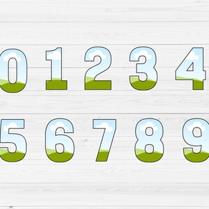 May include: Numbers 0 through 9 with a blue sky and green grass background. Each number is outlined in black.