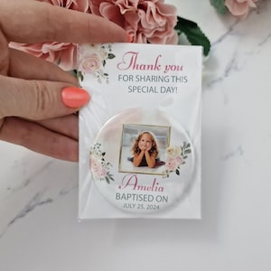 May include: A white round mirror with a floral design and a photo of a young girl. The mirror has the text "Thank you for sharing this special day!" and "Amelia Baptised on July 25, 2024".