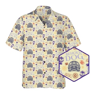 May include: A yellow short-sleeved button-down shirt with a repeating pattern of a turtle with the text "Behold Dog" on a light purple background. The turtle is surrounded by a pattern of small circles and flowers.