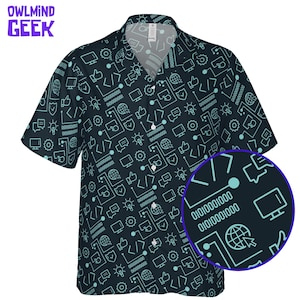 May include: A dark navy blue short-sleeve button-down shirt featuring a repeating light blue pattern of computer icons, including monitors, code brackets, binary numbers, globes, and light bulbs. The shirt has a collar and a front button closure.