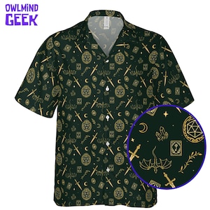 May include: Dark green button-up shirt with a repeating gold pattern of swords, moons, dice, and other fantasy-themed symbols. The shirt has short sleeves and a classic collar. The text "OWLMINND GEEK" is in the upper left corner.