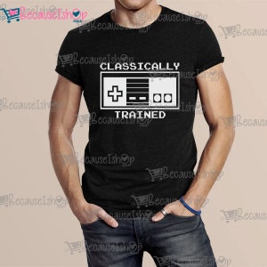 May include: A black t-shirt with a white graphic of a video game controller and the text "CLASSICALLY TRAINED".