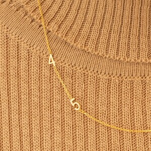 Reverse view of a Sterling Silver Personalized Number Charm, displaying its authenticity stamp. Confirms high-quality 925 sterling silver craftsmanship.