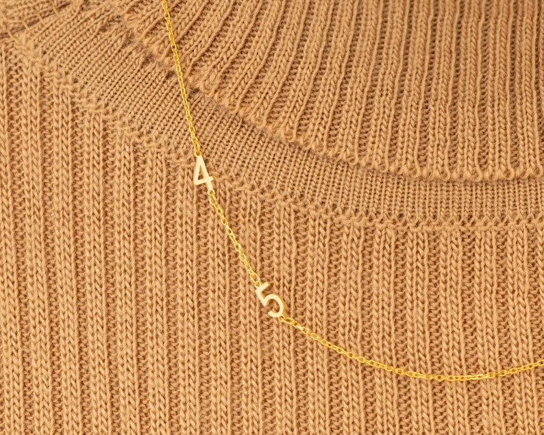 Reverse view of a Sterling Silver Personalized Number Charm, displaying its authenticity stamp. Confirms high-quality 925 sterling silver craftsmanship.