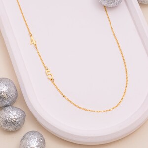Mannequin displays varied chain lengths for the Personalized Number Necklace, helping customers visualize drops and choose their ideal custom fit.