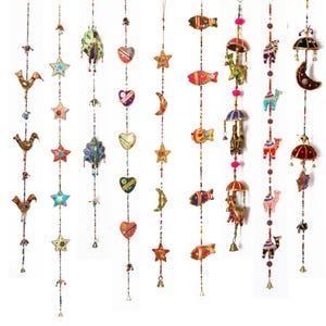 May include: A selection of decorative hanging ornaments featuring diverse shapes like birds, stars, hearts, fish, moons, umbrellas, and camels. The ornaments are adorned with embroidery and beads, creating a vibrant and detailed display.
