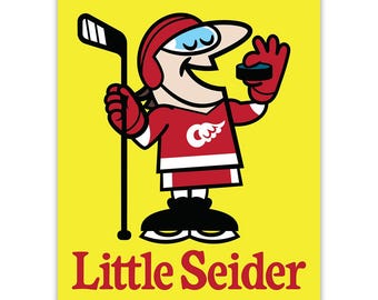 May include: A cartoon illustration of a hockey player wearing a red and white jersey with a red wing logo. The player is holding a hockey stick and a puck. The text "Little Seider" is written below the player.